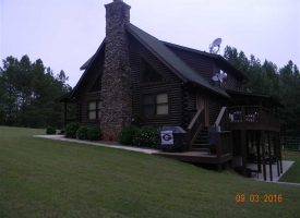 Come to the country on this 100 acres with beautiful log home